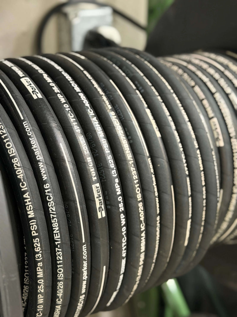 Close-up of hoses rolled on mount with visible Parker branding.