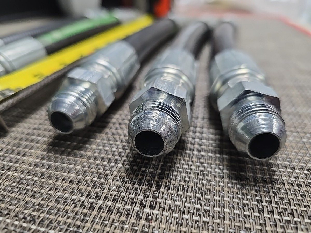 Metal plumbing connectors on a textured surface
