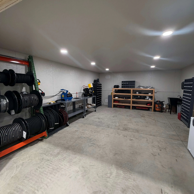 Hydraulic hoses, parts, machinery, and work room at Summit Compression shop. 